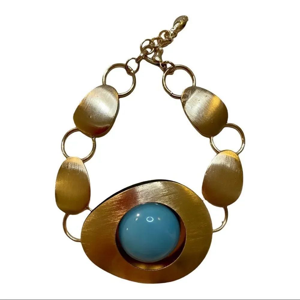 Brushed Gold Toned Bracelet with Teal Colored Bead as Centerpiece.